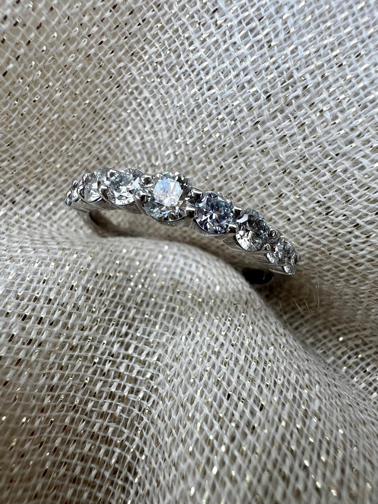 Diamond band with larger middle stone