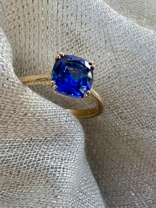 Cushion cut Tanzanite ring in yellow gold.