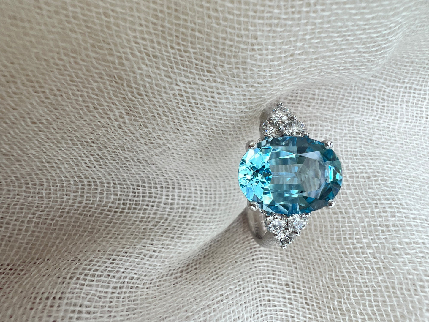 Oval Aquamarine ring with trio of diamonds.