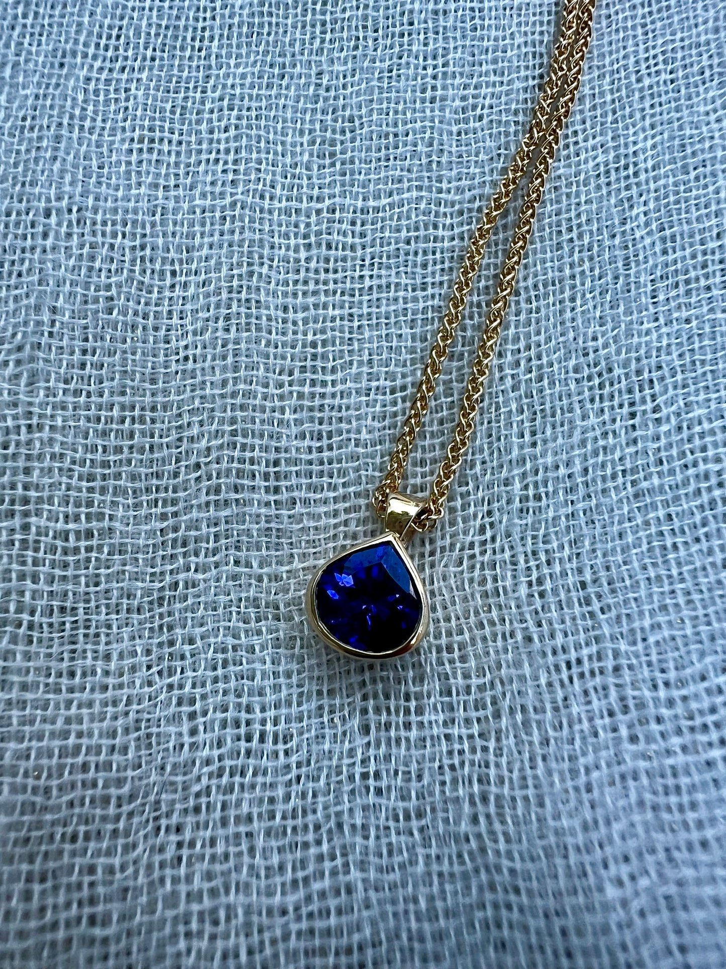 Tanzanite pear pendant in yellow gold