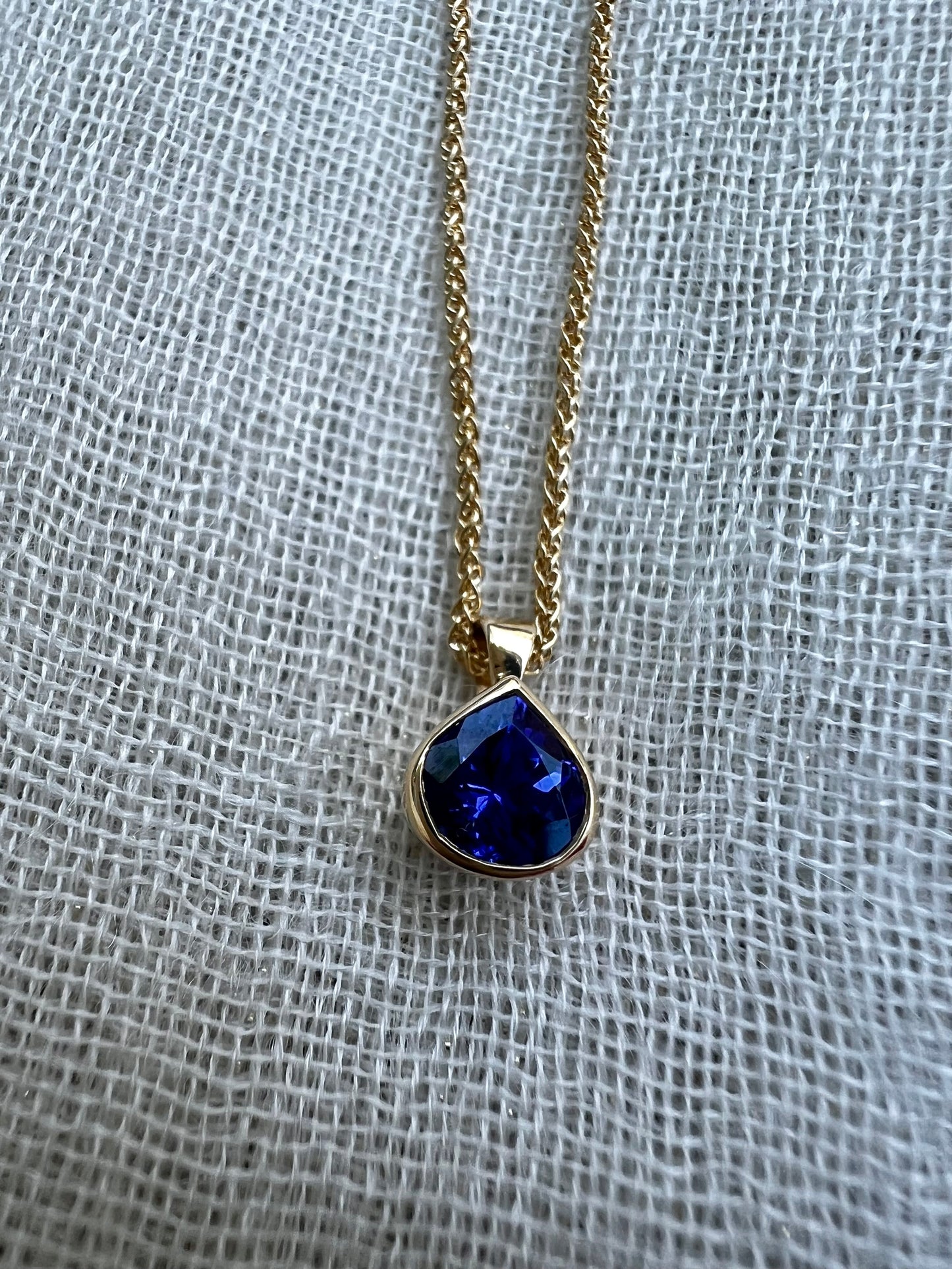 Tanzanite pear pendant in yellow gold