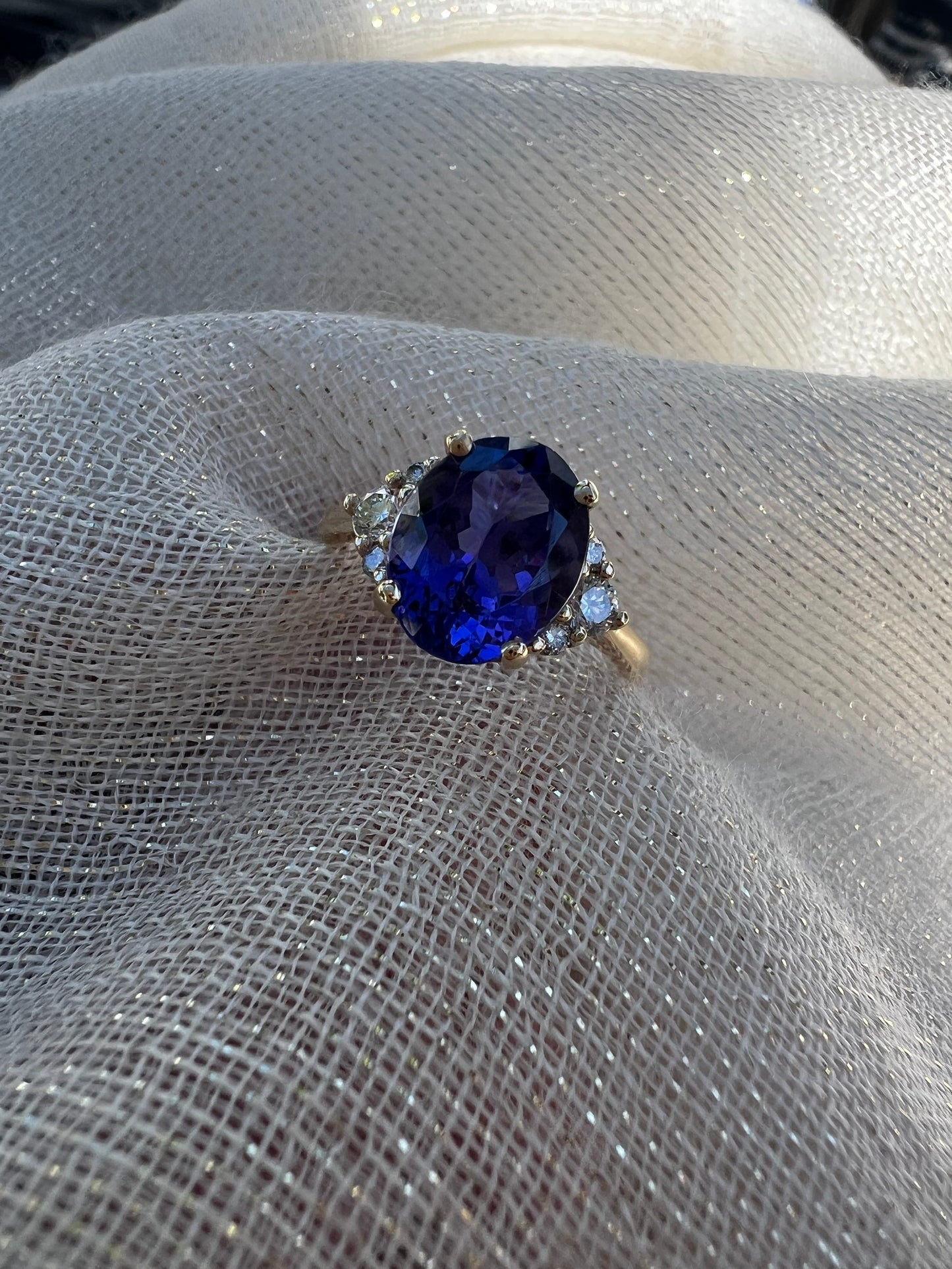 Oval Tanzanite with trio of diamonds