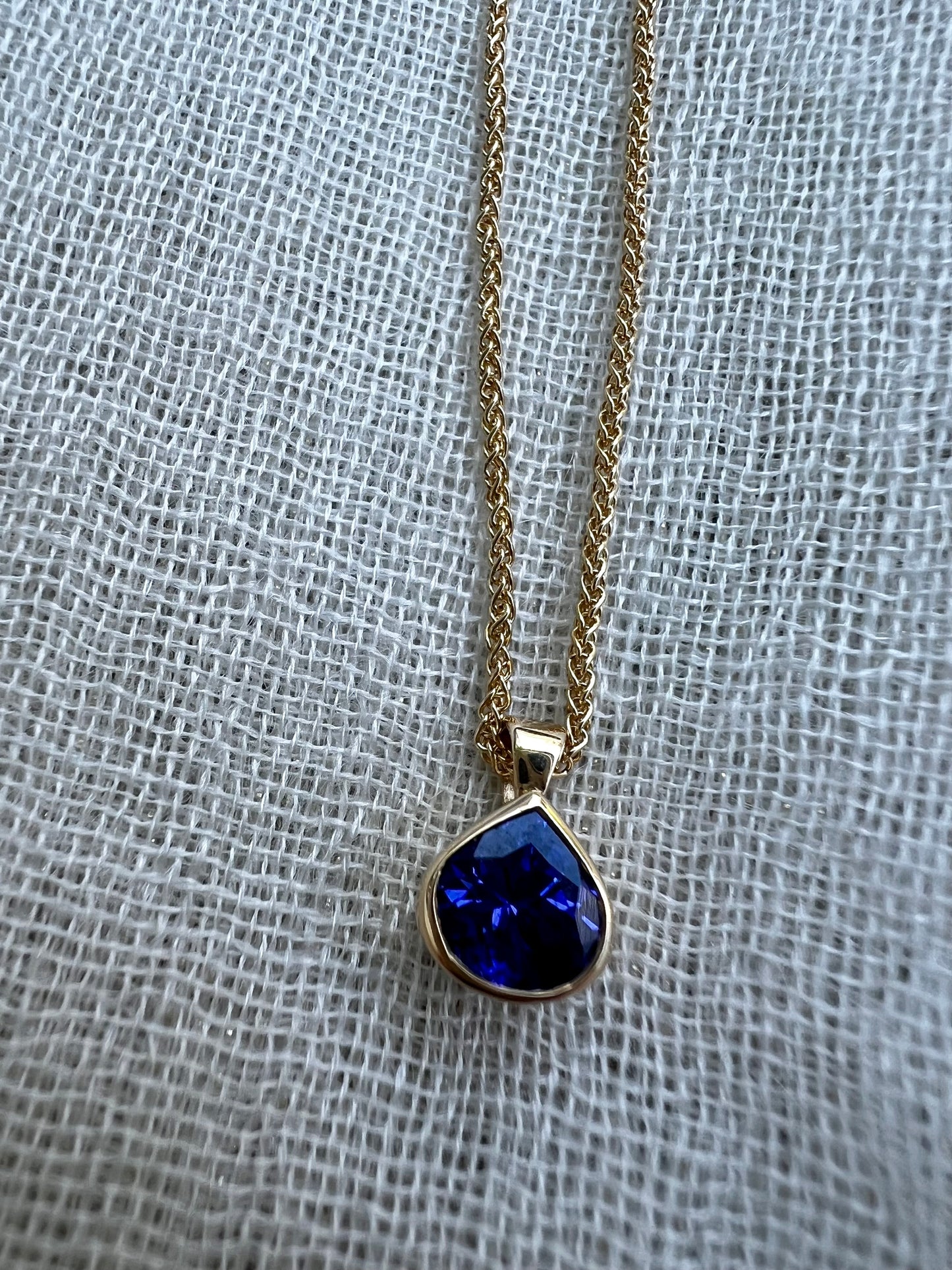 Tanzanite pear pendant in yellow gold