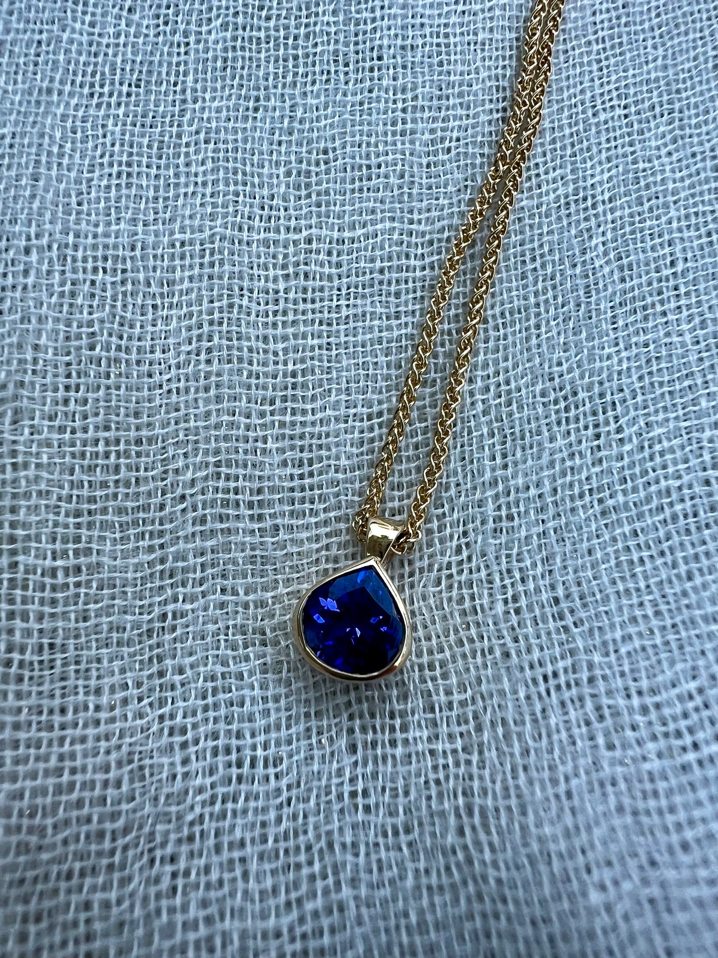 Tanzanite pear pendant in yellow gold