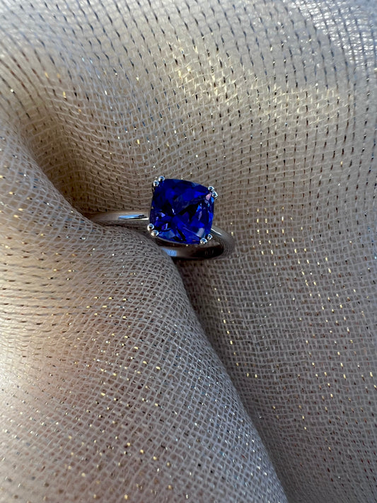 Cushion cut Tanzanite ring in white gold.