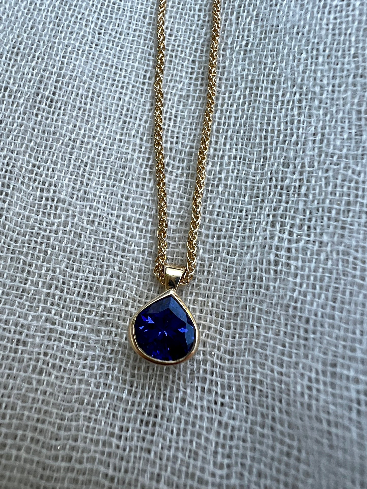 Tanzanite pear pendant in yellow gold