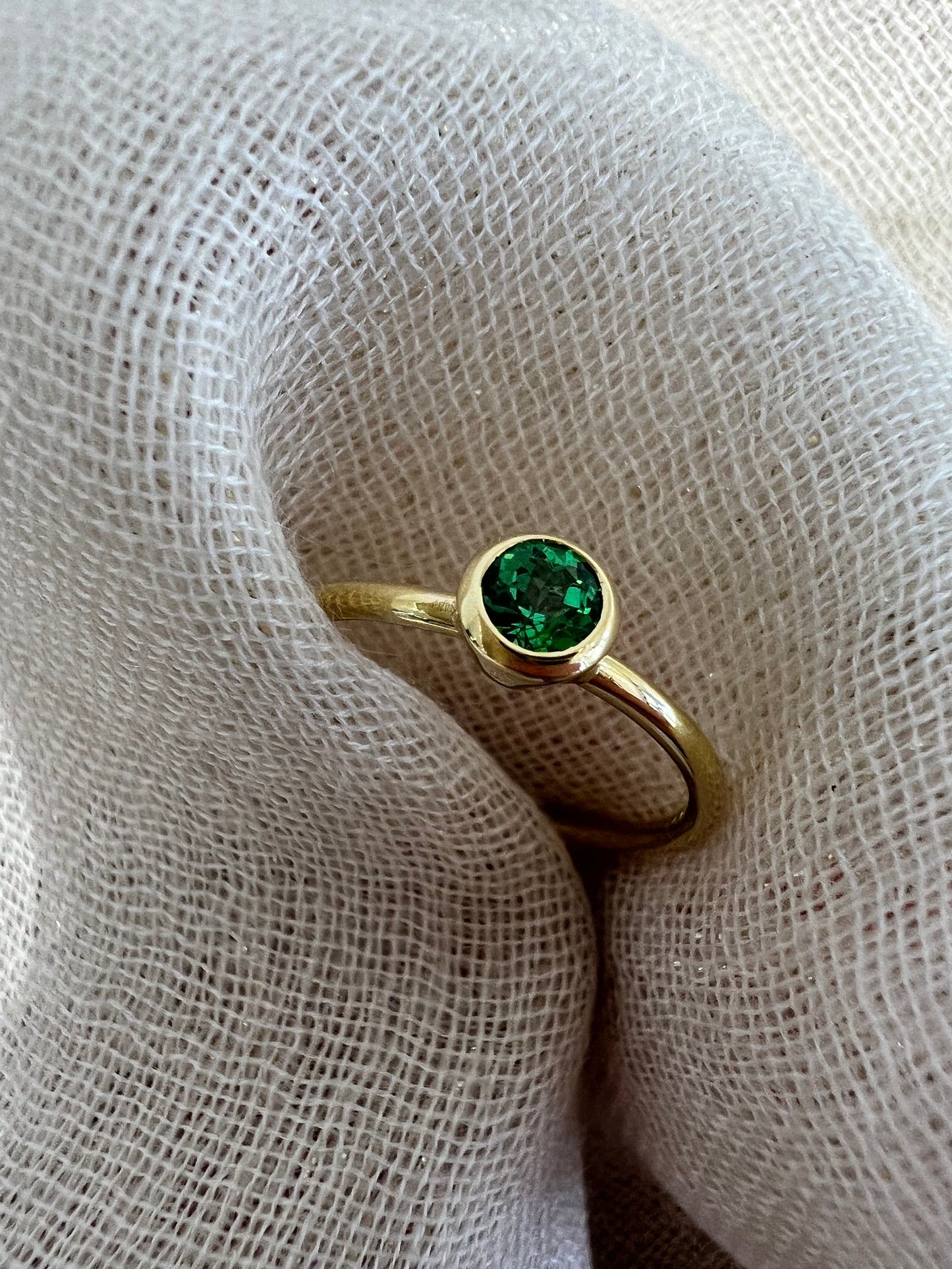 Tsavorite tube set ring in yellow gold