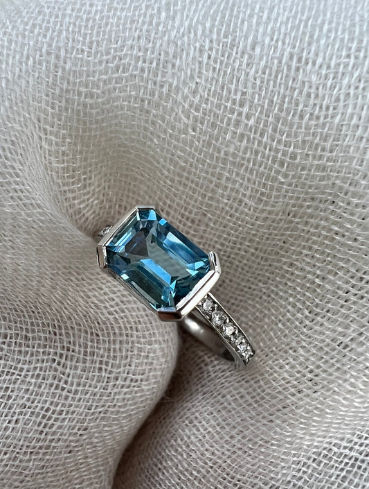 Aquamarine emerald cut side ring.