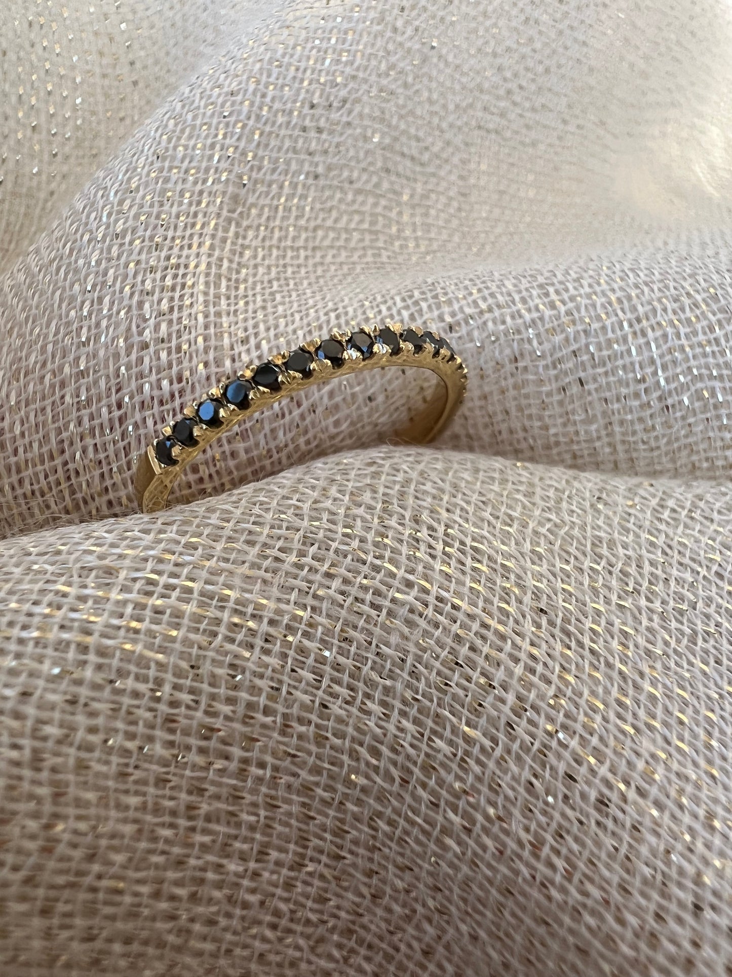 Black diamond half eternity ring in yellow gold