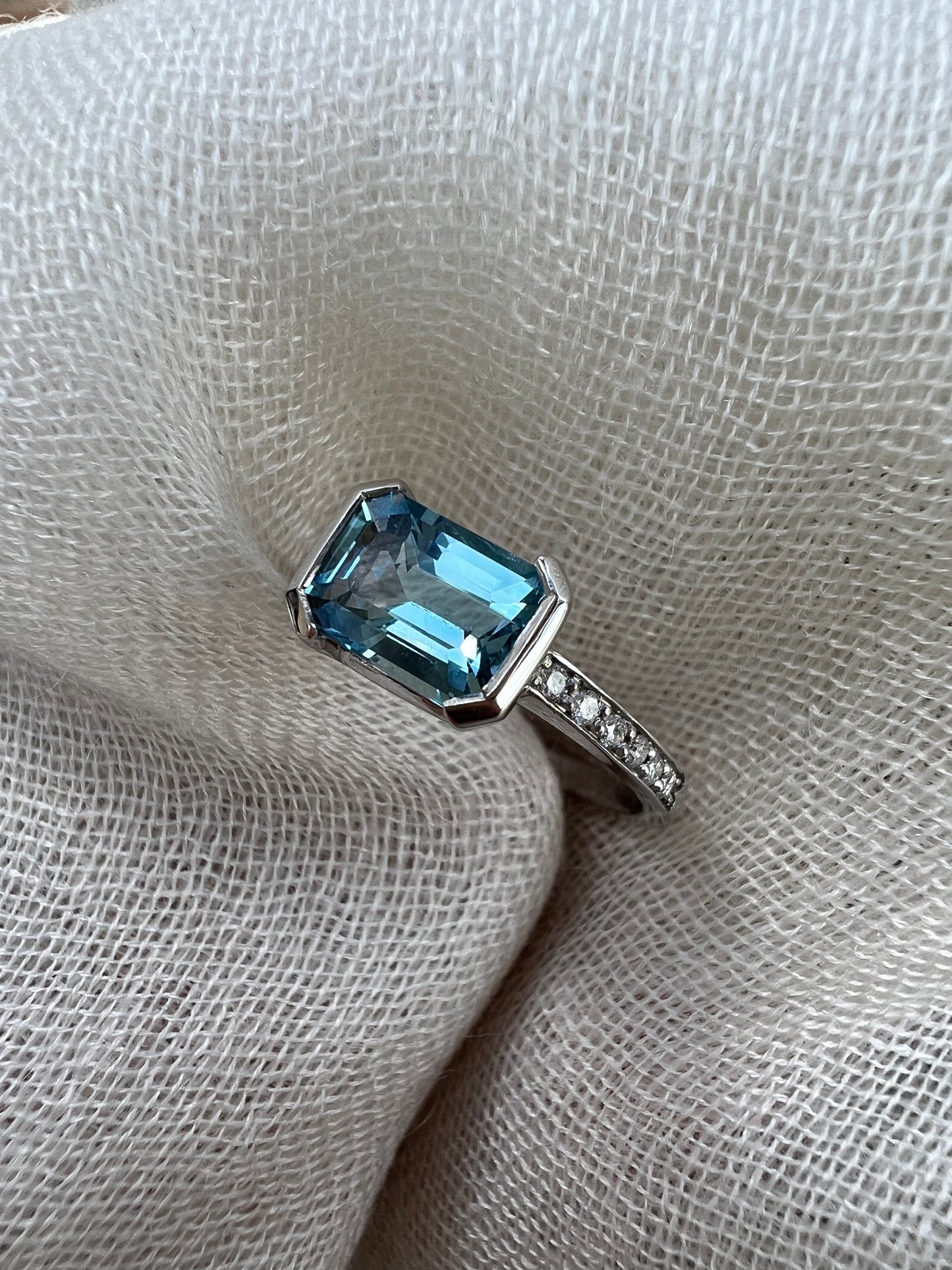 Aquamarine emerald cut side ring.