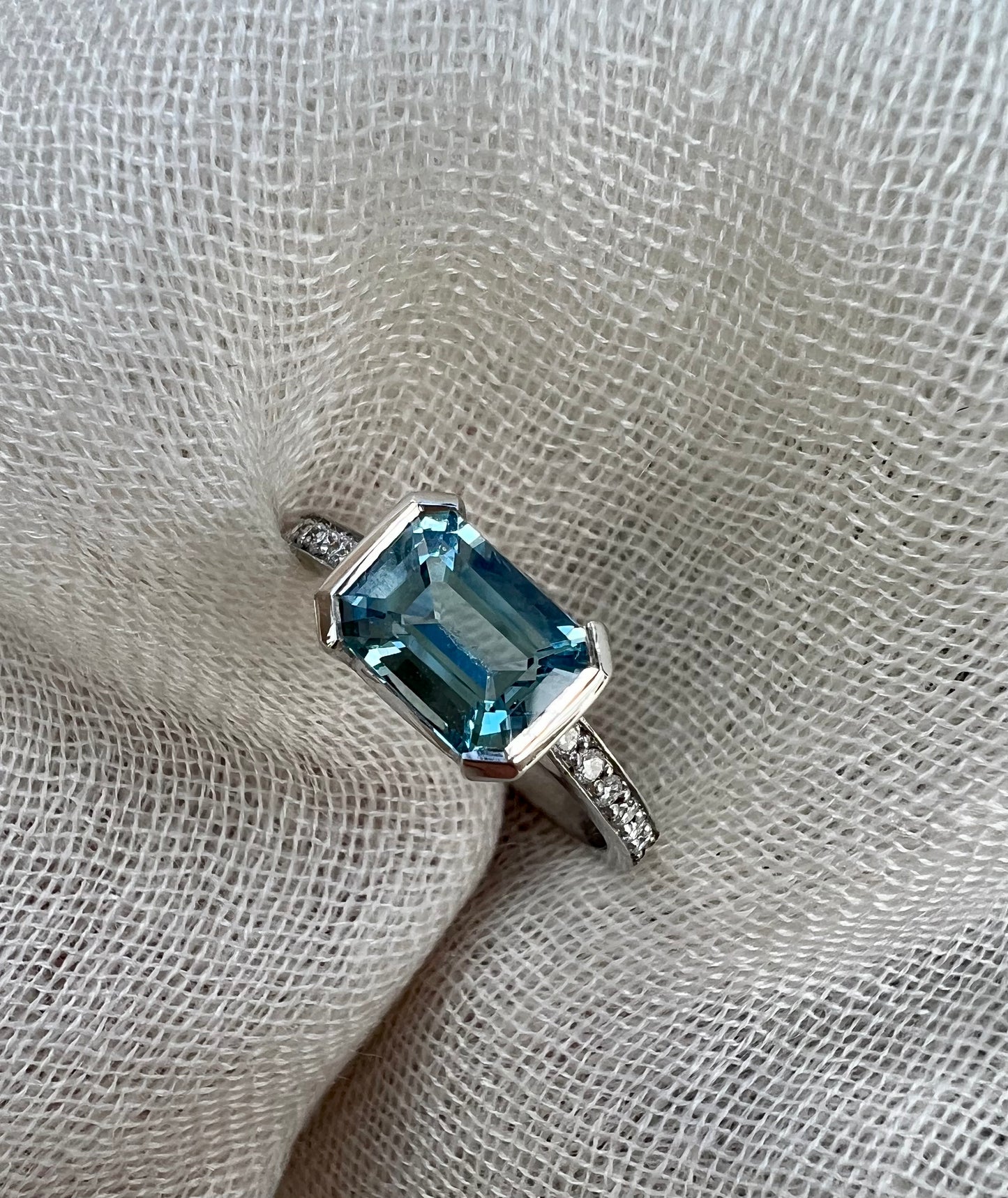 Aquamarine emerald cut side ring.