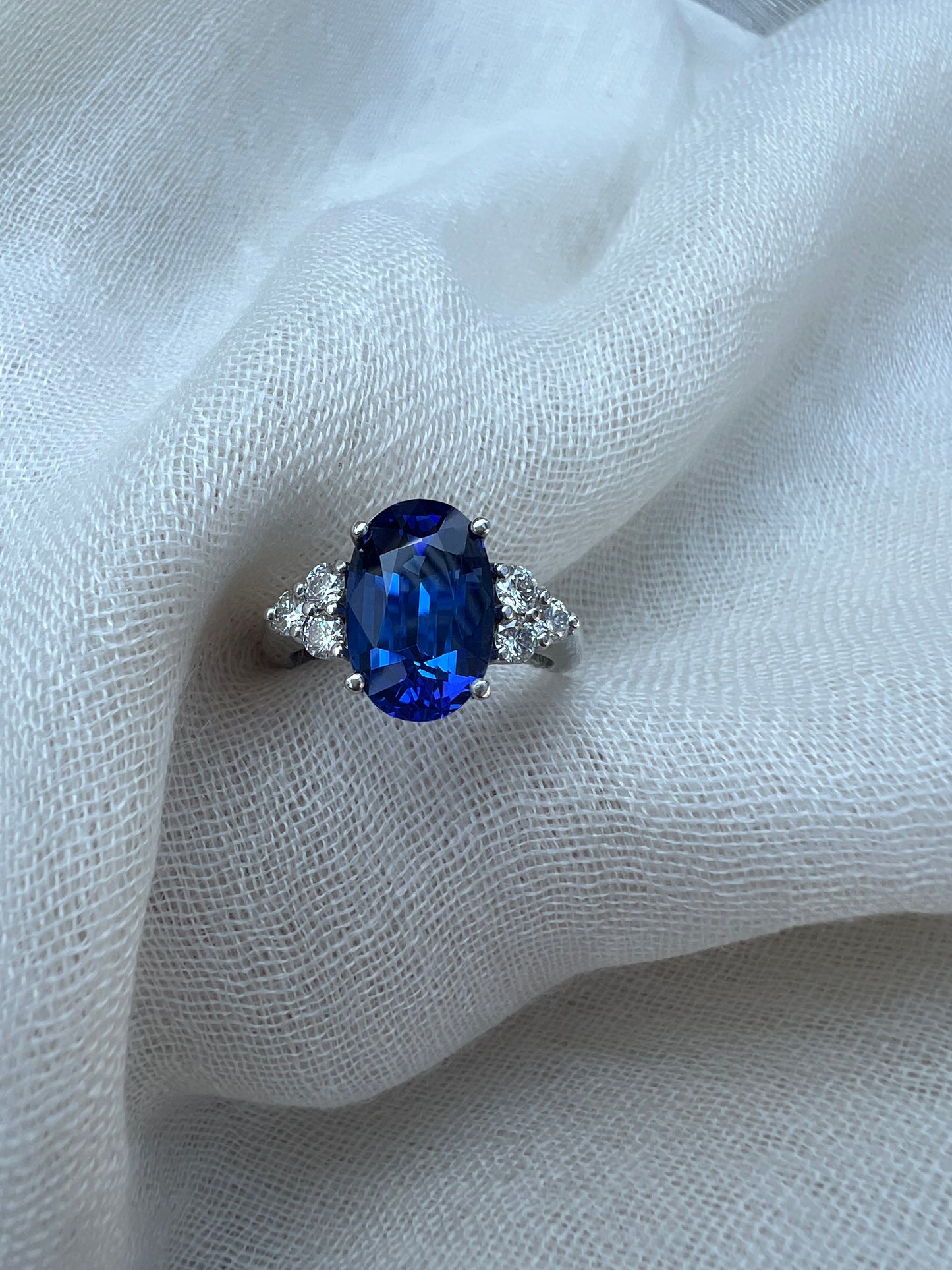 Oval Tanzanite ring with trio of diamonds