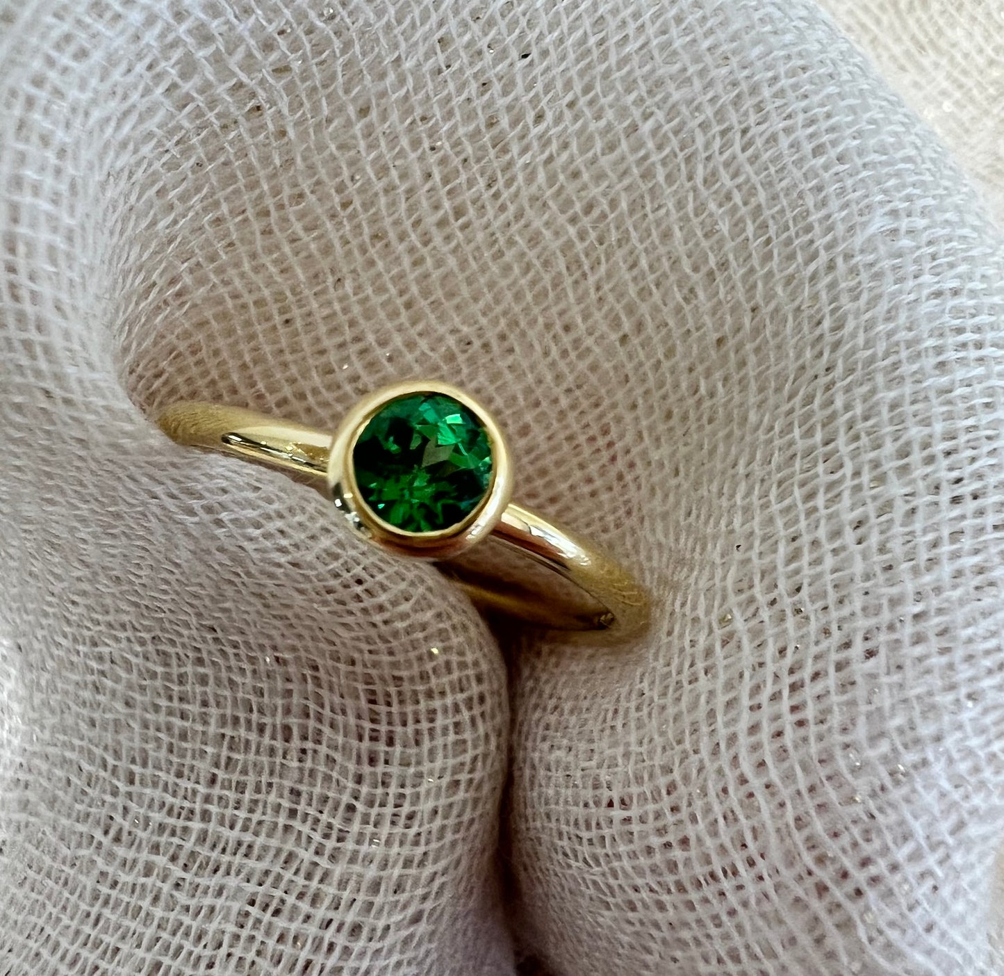 Tsavorite tube set ring in yellow gold