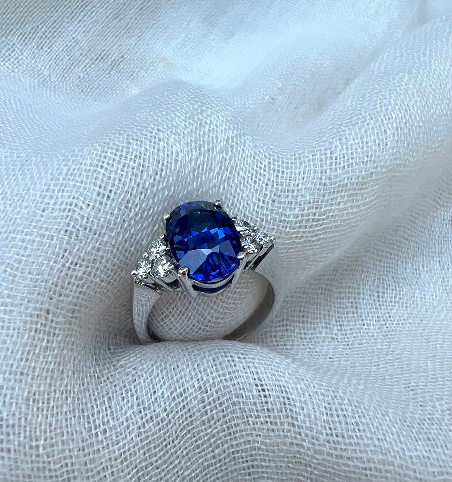 Oval Tanzanite ring with trio of diamonds